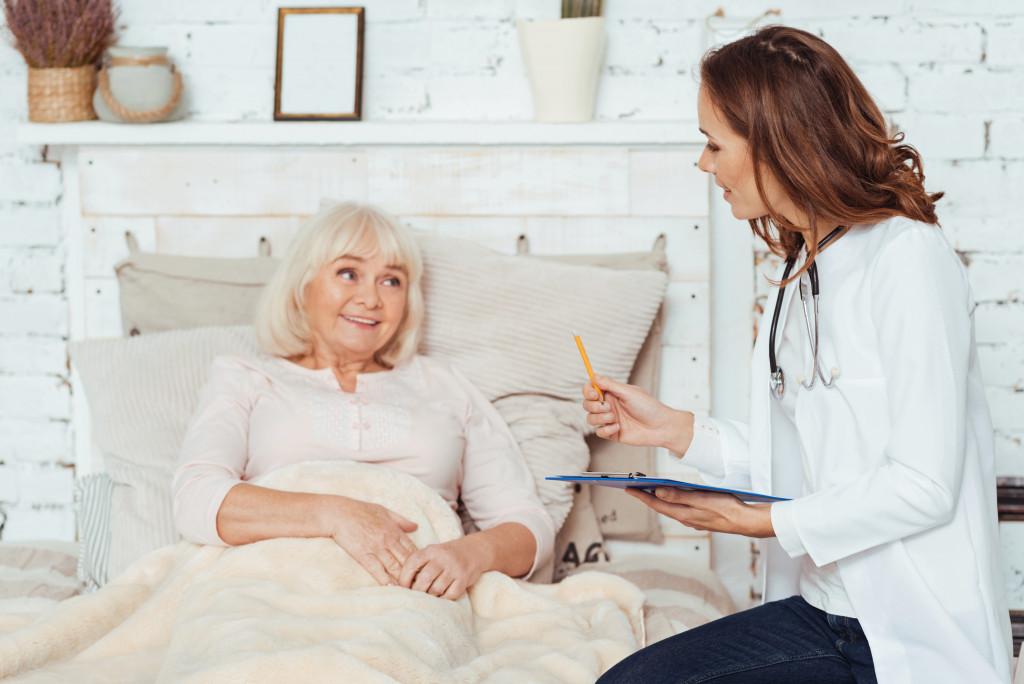 doctor talking to her patient in bed