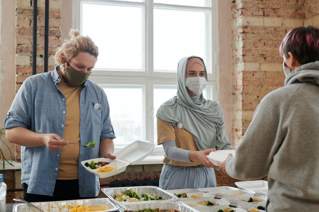 Volunteers Giving Out Meals Wearing Face Masks